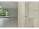 Bathroom with a well-lit vanity and an adjacent room with a tranquil water fountain view at 935 Sunridge Way # B4, Sarasota, FL 34234