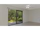 Bedroom featuring sliding glass doors offering serene views of the water and lush greenery at 935 Sunridge Way # B4, Sarasota, FL 34234