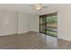Bright bedroom with wood-look floors and sliding glass doors to the outside at 935 Sunridge Way # B4, Sarasota, FL 34234