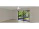 Spacious bedroom featuring a ceiling fan and sliding glass doors with a view of the water fountain at 935 Sunridge Way # B4, Sarasota, FL 34234