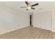 Bedroom with wood-look floors and spacious closet at 935 Sunridge Way # B4, Sarasota, FL 34234
