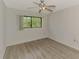 Bright bedroom with wood-look floors and a ceiling fan at 935 Sunridge Way # B4, Sarasota, FL 34234