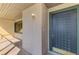 A front door with a storm door and exterior light fixture at 935 Sunridge Way # B4, Sarasota, FL 34234