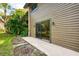 Exterior view of the home features a slider and a patio for relaxing and enjoying nature at 935 Sunridge Way # B4, Sarasota, FL 34234