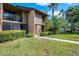Charming townhouse with a well-manicured lawn, lush landscaping, and a private balcony at 935 Sunridge Way # B4, Sarasota, FL 34234