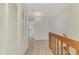 Upstairs hallway featuring storage closets, neutral walls, and a staircase leading to the first floor at 935 Sunridge Way # B4, Sarasota, FL 34234