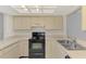 Efficient kitchen setup with classic cabinets and appliances providing functionality at 935 Sunridge Way # B4, Sarasota, FL 34234