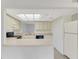 Well-lit kitchen featuring countertops, cabinets, and a bright atmosphere at 935 Sunridge Way # B4, Sarasota, FL 34234