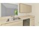 Kitchen sink and dishwasher with view from open window at 935 Sunridge Way # B4, Sarasota, FL 34234