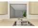 Bright kitchen featuring a stainless steel sink and a pass-through window to the living area at 935 Sunridge Way # B4, Sarasota, FL 34234