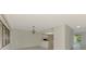 Bright living room with tile floors, chandelier, and open kitchen view at 935 Sunridge Way # B4, Sarasota, FL 34234