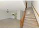 Open-concept living space with staircase and pass through to bright kitchen at 935 Sunridge Way # B4, Sarasota, FL 34234