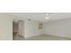 Open living room with tile floors, ceiling fan, and an open view to the kitchen area at 935 Sunridge Way # B4, Sarasota, FL 34234