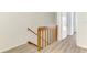 Second-floor landing with a wooden railing and a view of the staircase leading down to the first floor at 935 Sunridge Way # B4, Sarasota, FL 34234