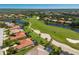 Scenic aerial shot of houses next to a golf course with ponds and lush greenery, showcasing community at 9719 Discovery Ter, Bradenton, FL 34212