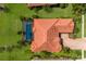 Overhead view of a beautiful home with a pool surrounded by a screened enclosure and lush landscaping at 9719 Discovery Ter, Bradenton, FL 34212