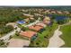 Scenic aerial shot of houses next to a golf course with ponds and lush greenery, showcasing community at 9719 Discovery Ter, Bradenton, FL 34212
