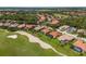Expansive aerial showcasing an elegant golf community's lush landscaping and community lakes at 9719 Discovery Ter, Bradenton, FL 34212
