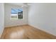 Bedroom with hardwood floors, window, and neutral wall color at 9719 Discovery Ter, Bradenton, FL 34212