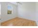 Bedroom featuring a ceiling fan, window with blinds, and hardwood floors at 9719 Discovery Ter, Bradenton, FL 34212