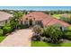 Beautiful home featuring a red tile roof, manicured landscaping and a brick paver driveway on a sunny day at 9719 Discovery Ter, Bradenton, FL 34212