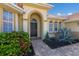 Arched doorway leads to a black front door, framed by lush landscaping and a brick paver walkway at 9719 Discovery Ter, Bradenton, FL 34212