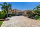 Charming home with a paver driveway, lush landscaping, and a tile roof that offers great curb appeal at 9719 Discovery Ter, Bradenton, FL 34212