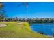 Community golf course view with lake, providing a scenic backdrop for golfers and outdoor recreation at 9719 Discovery Ter, Bradenton, FL 34212