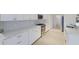 Bright kitchen features white cabinets, stainless steel appliances, marble countertops, and tiled backsplash at 9719 Discovery Ter, Bradenton, FL 34212