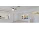 Open-concept living room features neutral paint, tiled floors, arched doorways, and a decorative chandelier at 9719 Discovery Ter, Bradenton, FL 34212