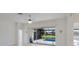 Bright living room features neutral paint, a decorative ceiling fan, and sliding glass doors leading to the lanai at 9719 Discovery Ter, Bradenton, FL 34212