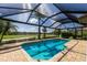 Stunning screened pool featuring lush landscaping and golf course views at 9719 Discovery Ter, Bradenton, FL 34212