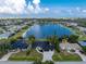 Expansive aerial view highlighting lakefront property with numerous surrounding homes and green spaces at 10055 Franklin Dr, Englewood, FL 34224