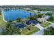 Beautiful waterfront home featuring lush landscaping and a serene lake view at 10055 Franklin Dr, Englewood, FL 34224
