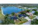Aerial view of lakeside home with lush landscaping and screened-in porch at 10055 Franklin Dr, Englewood, FL 34224