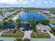 Beautiful waterfront home featuring lush landscaping and a serene lake view at 10055 Franklin Dr, Englewood, FL 34224