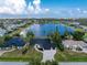 Aerial view of property with lake, lush surroundings, and neighboring homes at 10055 Franklin Dr, Englewood, FL 34224