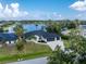 Aerial view of house and yard with large lake as a backdrop at 10055 Franklin Dr, Englewood, FL 34224