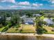 Aerial view of lush backyard featuring a screened-in pool and water access at 10055 Franklin Dr, Englewood, FL 34224
