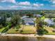 Aerial view of lush backyard featuring a screened-in pool and water access at 10055 Franklin Dr, Englewood, FL 34224