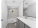 Bathroom featuring a shower/tub combo with marble-style tile and a gray vanity at 10055 Franklin Dr, Englewood, FL 34224