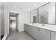 Bathroom with double sinks and walk-in shower at 10055 Franklin Dr, Englewood, FL 34224