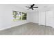 A bright bedroom with wood-look tile floors and a picturesque view of the lake at 10055 Franklin Dr, Englewood, FL 34224