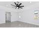 Bright bedroom featuring a modern ceiling fan, recessed lighting, and gray tile flooring at 10055 Franklin Dr, Englewood, FL 34224