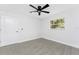 Bedroom features a ceiling fan, and a sunlit window overlooking lush greenery at 10055 Franklin Dr, Englewood, FL 34224