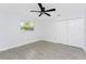 Bright bedroom with a modern ceiling fan, double closet doors, and gray tile flooring at 10055 Franklin Dr, Englewood, FL 34224