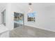 Bright dining area with tile floors, pendant lighting, and sliding doors offering views of the screened-in lanai and pool at 10055 Franklin Dr, Englewood, FL 34224