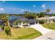 Beautiful home with a well-manicured lawn and a spacious three-car garage at 10055 Franklin Dr, Englewood, FL 34224