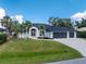 Charming two-story home with a three car garage and tropical landscaping at 10055 Franklin Dr, Englewood, FL 34224