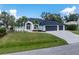 Charming two-story home with a well-manicured lawn, lush landscaping and a three car garage at 10055 Franklin Dr, Englewood, FL 34224